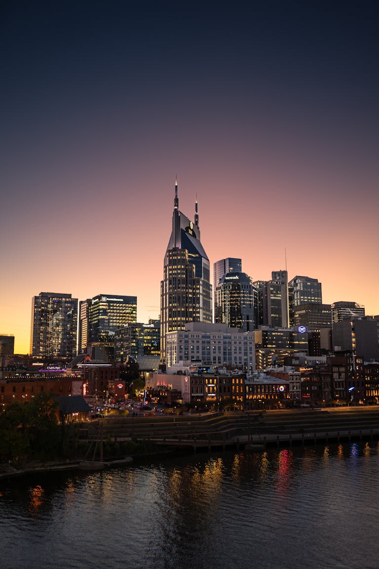 Stunning view of Nashville's skyline with AT&T Building at sunset, illuminating modern architecture.